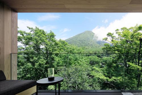 a room with a large window with a view of the mountains at The Ritz-Carlton, Nikko in Nikko