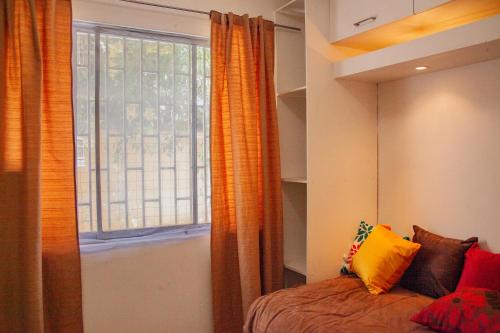 a bedroom with a bed and a large window at COZY POCKET SIZE SWEET DEAL in Santiago