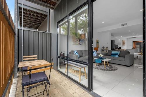 un salon avec un canapé et une table dans l'établissement 2BR Townhouse CBD Chinatown Free WiFi FreeParking, à Adélaïde