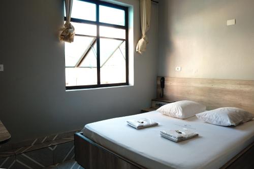 a bedroom with a bed with two towels on it at Hotel city Clélia in Sao Paulo