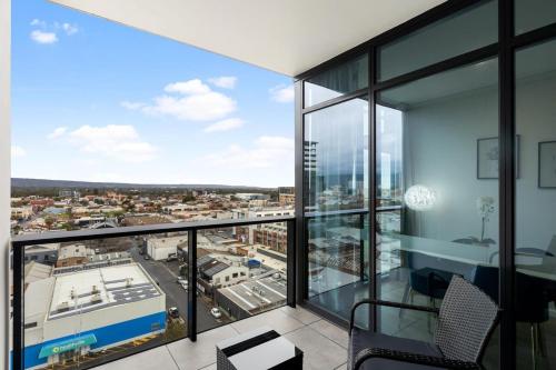 an apartment balcony with a view of a city at The elegant 1BR CBD Apt - City view - Parking in Adelaide