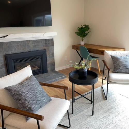 a living room with chairs and a fireplace at Bright Napa Home in Napa