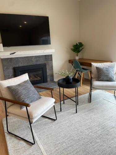 a living room with two chairs and a fireplace at Bright Napa Home in Napa