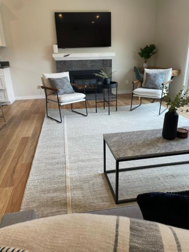 a living room with a flat screen tv above a fireplace at Bright Napa Home in Napa