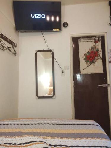 a sign on a wall above a door with a mirror at Departamento en el centro Histórico CDMX Bolivar 8 Edificio SANTA CLARA in Mexico City