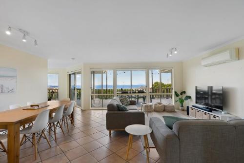 a living room with a couch and a table at 48 Rumbelow St - BYO Linen - Sea Views - Family Friendly in Encounter Bay
