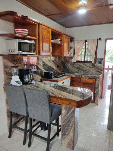 a kitchen with a wooden counter top in a room at Departamento Ángeles del Arenal #2 in Fortuna