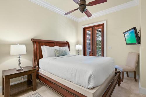 a bedroom with a bed and a ceiling fan at Le Jardin 154 in Destin