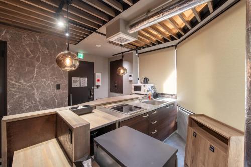 a kitchen with a sink and a counter at NEXUS HOTEL Gotanda in Tokyo