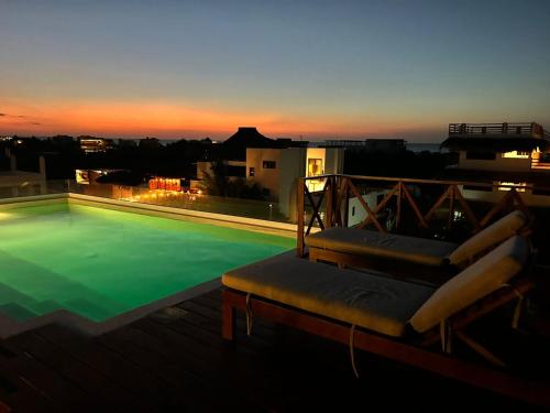 a swimming pool on the roof of a building at Sunsteps casa holbox in Holbox Island