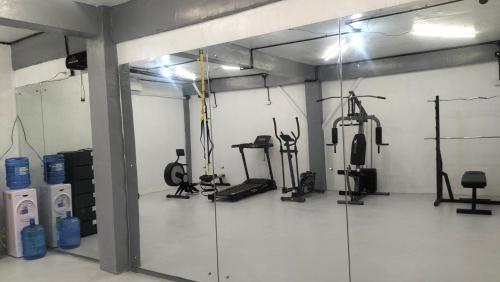 a gym with several exercise equipment in a room at Answer hotel in Puerto Galera