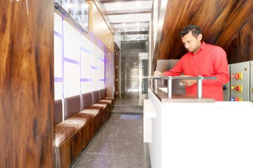 a man standing at a counter in a restaurant at OYO Hotel Galaxy in Bathinda