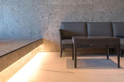 a bench and a table in a room at Dignity Hotel in Yangyang