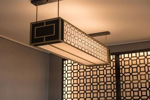 a large light fixture hanging from a ceiling at Dignity Hotel in Yangyang