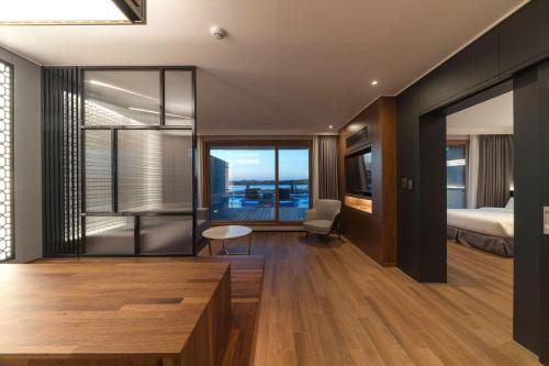 a hotel room with a bed and a bedroom with a window at Dignity Hotel in Yangyang