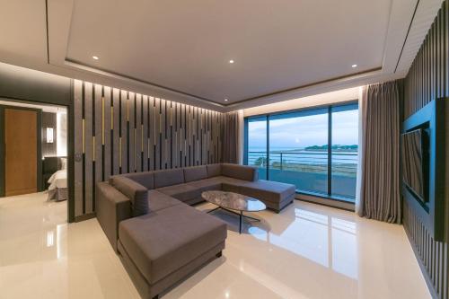 a living room with a couch and a table at Dignity Hotel in Yangyang