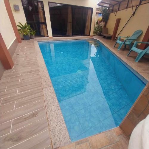 a swimming pool with blue water in a house at Eli's Villa Cebu in Cebu City
