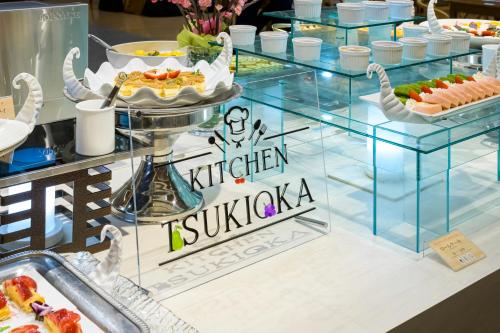 a buffet with a sign that reads kitchen sushiaza at Senkeien Tsukioka Hotel in Kaminoyama