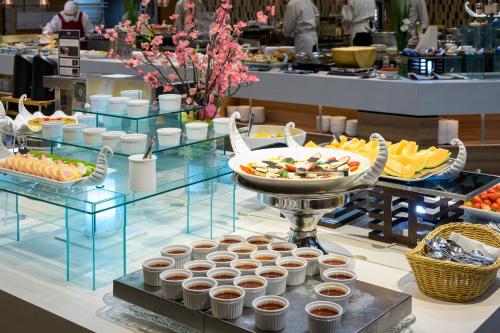 a buffet of food on a table in a restaurant at Senkeien Tsukioka Hotel in Kaminoyama