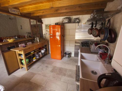 an overhead view of a kitchen with an orange refrigerator at Gîte de Charme Rénové, Idéal Famille, Centre-Ville, WiFi, Parking Gratuit, Vélo Bienvenue - FR-1-381-268 in Loches