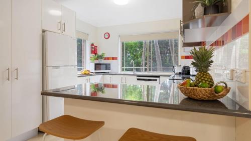 a kitchen with a counter with a bowl of fruit at Bombo Blue in Kiama