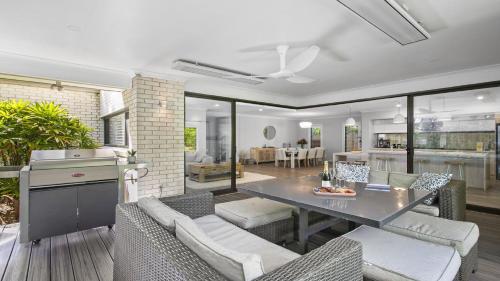 a kitchen and living room with a table and chairs at Paradise in Pearl-walk to beach, ducted air in Pearl Beach