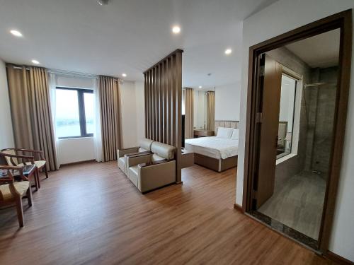 a hotel room with a bed and a mirror at Glory Hotel Apartment Hải Phòng in Hai Phong