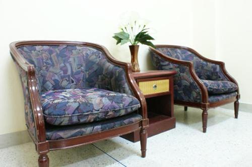 two chairs sitting next to a table with a plant at Kim Hotel At Bangplong in Ban Bang Prong