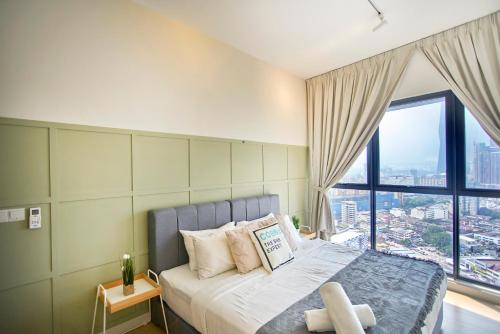 a bedroom with a bed with a large window at Continew Residence TRX KL in Kuala Lumpur