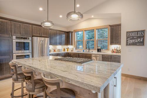 a kitchen with a large island in a kitchen with wooden cabinets at Wooded Bliss in Carnelian Bay