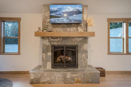 a living room with a fireplace with a tv on top at Wooded Bliss in Carnelian Bay
