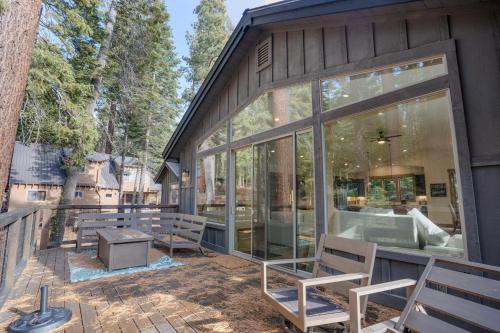 a screened in porch of a house with benches at Wooded Bliss in Carnelian Bay