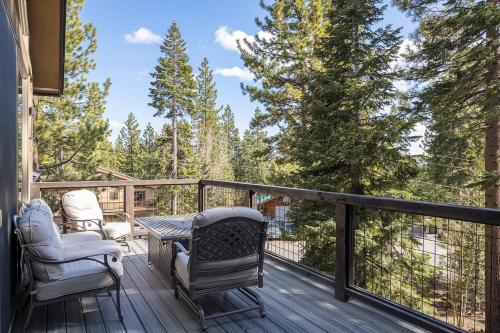 a deck with chairs and a table on a deck at Tahoe Tranquili-Tree in Kings Beach
