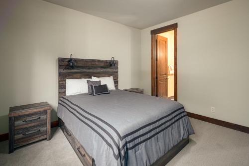 a bedroom with a bed with a laptop on it at Tahoe Tranquili-Tree in Kings Beach