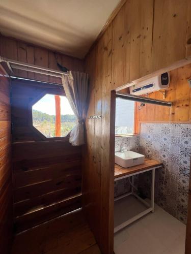 a bathroom with a sink and a window at Lưng Chừng House in Da Lat
