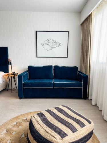 a blue couch in a living room with a rug at Waves Byron Bay in Byron Bay