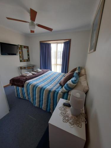 Schlafzimmer mit einem Bett und einem Fenster in der Unterkunft Kangaroo Island Accommodation in Kingscote