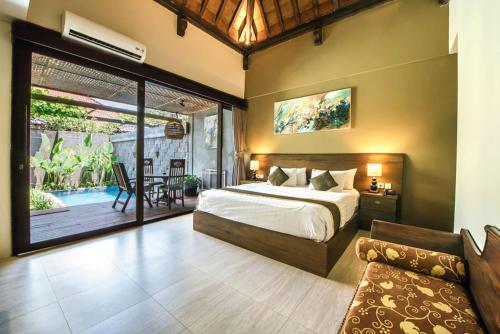 a bedroom with a bed and a living room at ME Villas Echo Beach Canggu in Canggu