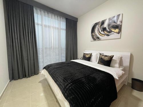 a bedroom with a large bed and a window at CMA Skyline Sanctuary Apartments - Ajman Corniche UAE in Ajman 