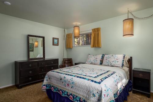 a bedroom with a bed and a dresser and a mirror at Agate Bay Ranch in Carnelian Bay