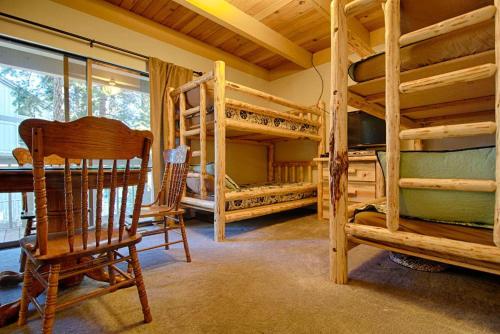 a room with bunk beds and a chair and a table at Bed-N-Bliss in Kings Beach