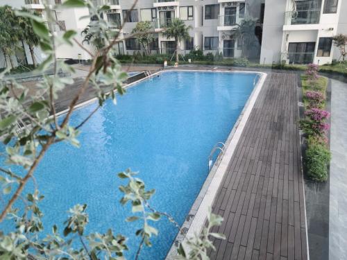 a swimming pool in front of a building at Ina apartment - Nera garden Hue in Hue