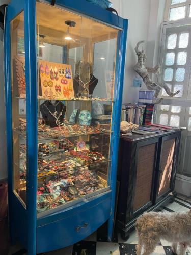 a blue cabinet filled with lots of different items at La Casa del Kéej Hostel in Mérida