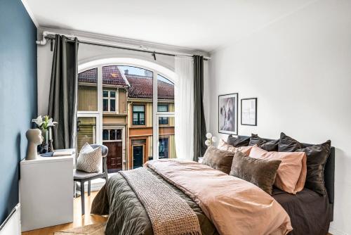 a bedroom with a bed and a large window at 3 Bedroom with a perfect location in Trondheim in Trondheim