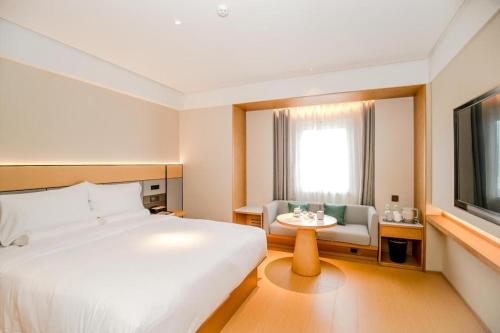 سرير أو أسرّة في غرفة في Ji Hotel Yantai International Expo Center
