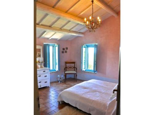 1 dormitorio con cama y lámpara de araña en Lovely apartment in Ripatransone AP, 