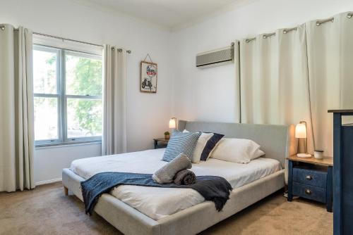 een slaapkamer met een bed en een groot raam bij Spacious 3-Bed with Amazing Views in Norman Park in Brisbane