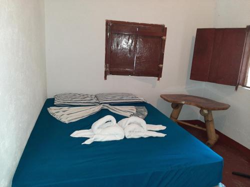a room with a bed with towels on it at Playa Casa Nohelia in Santo Domingo