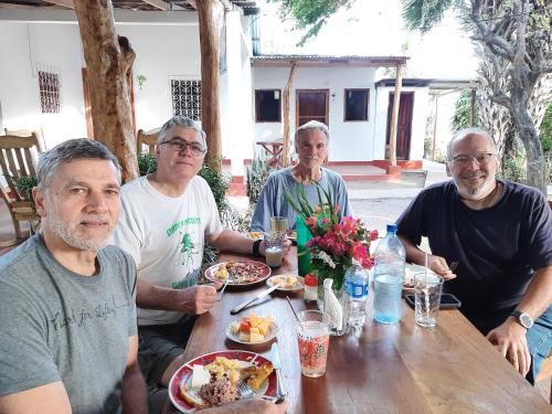 a group of people sitting at a table eating food at Playa Casa Nohelia in Santo Domingo