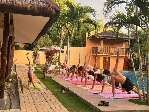 a group of people doing yoga by a pool at Abraham Bohol in Panglao